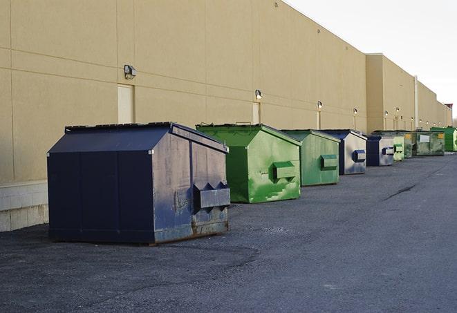 a group of dumpsters lined up along the street ready for use in a large-scale construction project in Apple Valley, MN